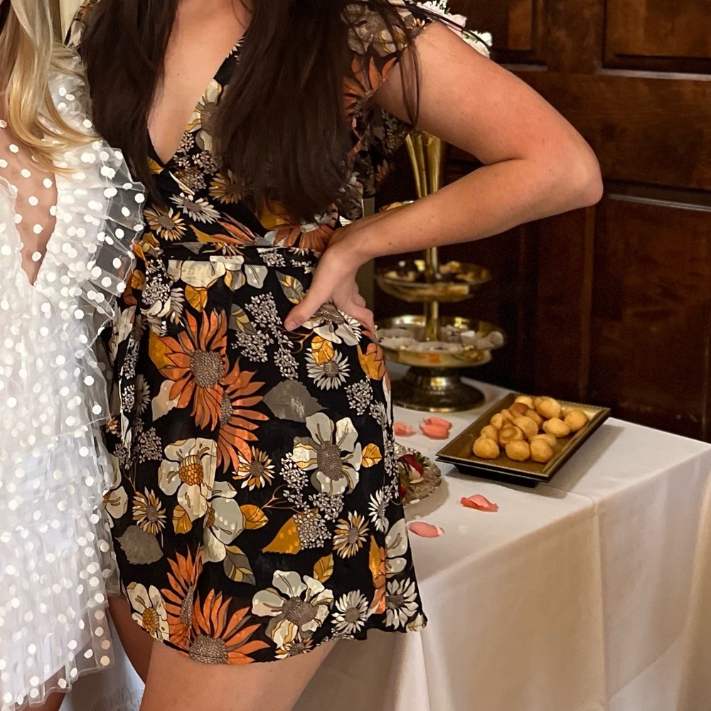 Black floral dress. Ruffles on edges of sleeves